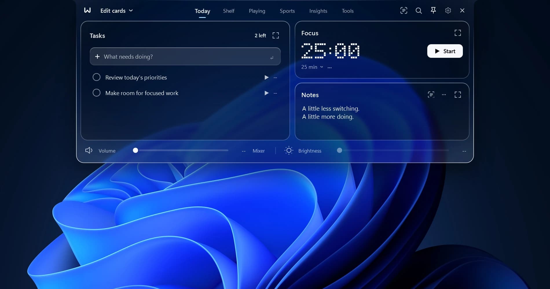 WinNotch open at the top of the screen in the Liquid Glass theme, the Windows 11 wallpaper showing through it